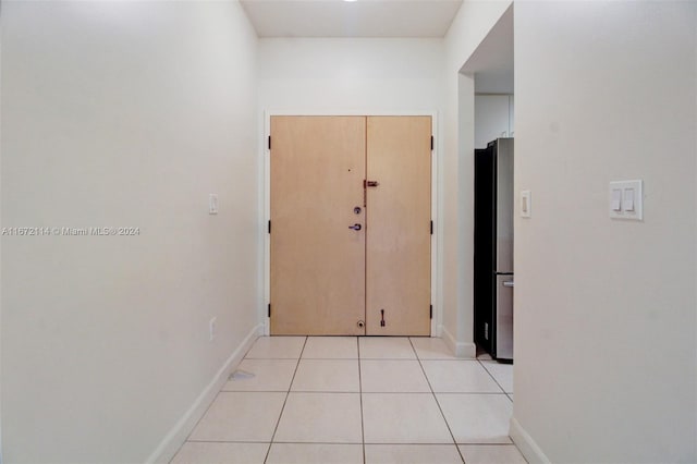 hallway featuring light tile patterned floors