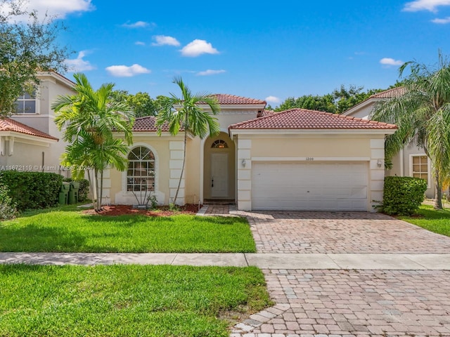 mediterranean / spanish house with a front yard and a garage