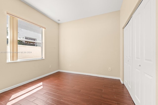 unfurnished bedroom with a closet and hardwood / wood-style flooring