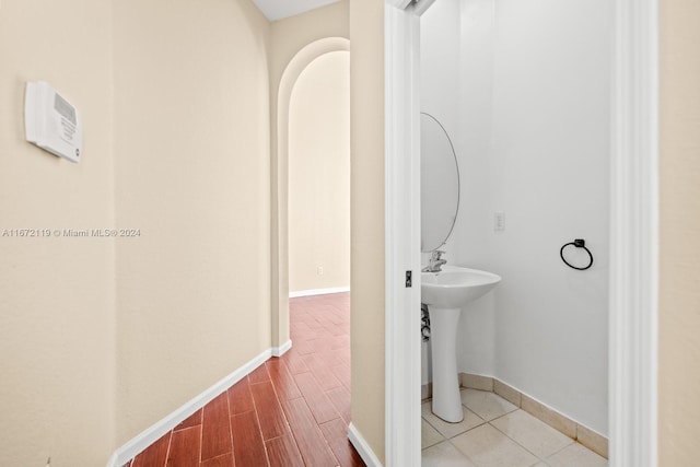 bathroom featuring wood-type flooring and sink