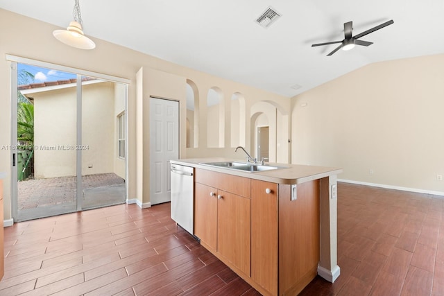 kitchen featuring an island with sink, lofted ceiling, sink, stainless steel dishwasher, and dark wood-type flooring