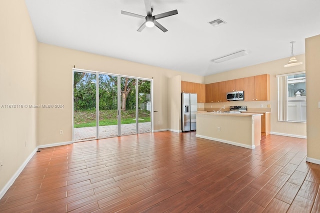 unfurnished living room with light wood-type flooring, sink, and ceiling fan