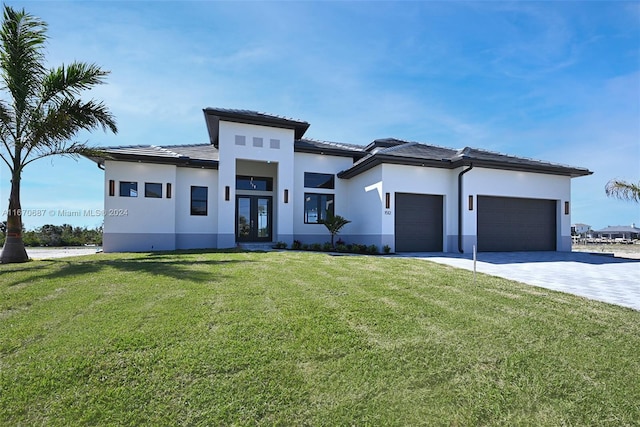 prairie-style home with a front lawn and a garage