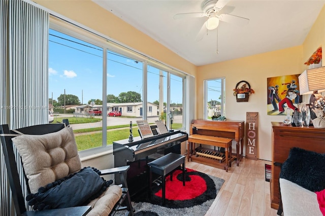 sunroom / solarium with a ceiling fan