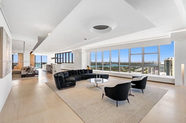 living room featuring plenty of natural light and a water view