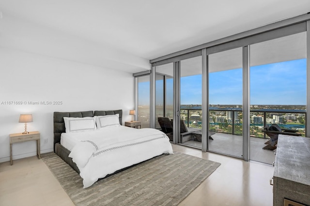 bedroom featuring access to exterior and a wall of windows