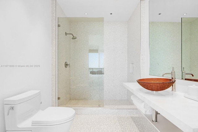 bathroom with tile patterned floors, toilet, sink, and a tile shower