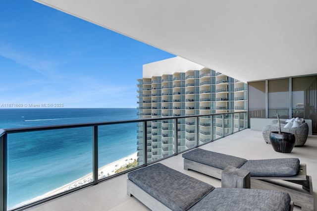 balcony with a water view and a beach view