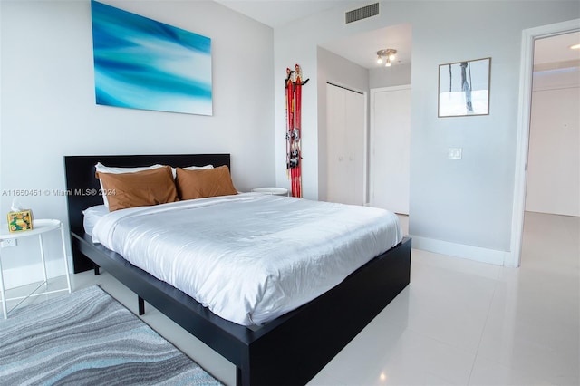 tiled bedroom featuring a closet