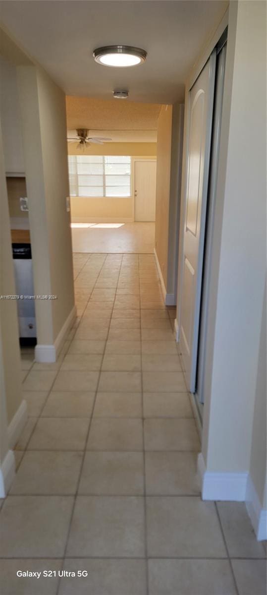 hallway with light tile patterned floors