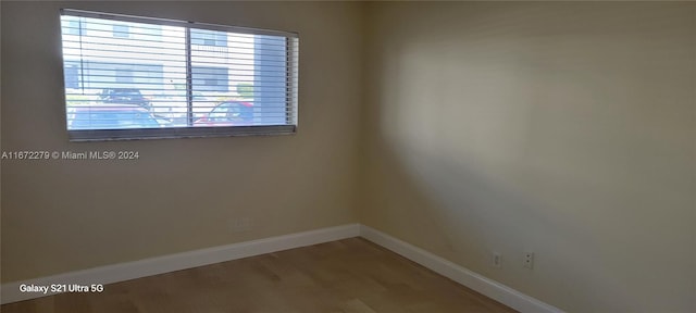 empty room with wood-type flooring