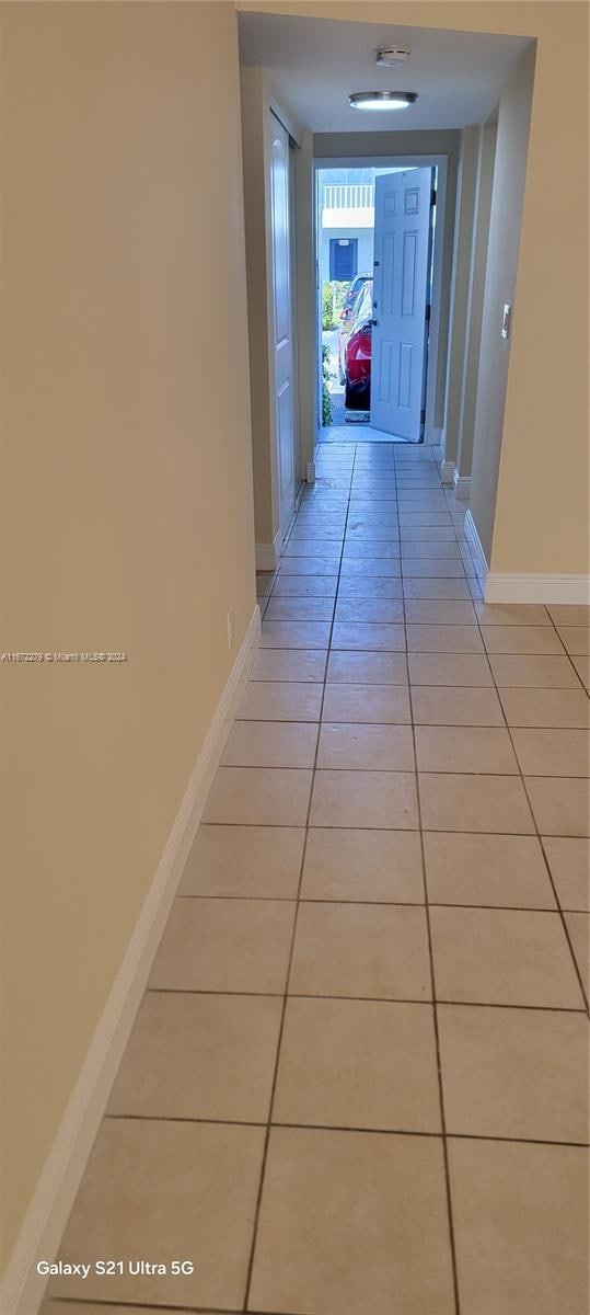 hallway with light tile patterned floors