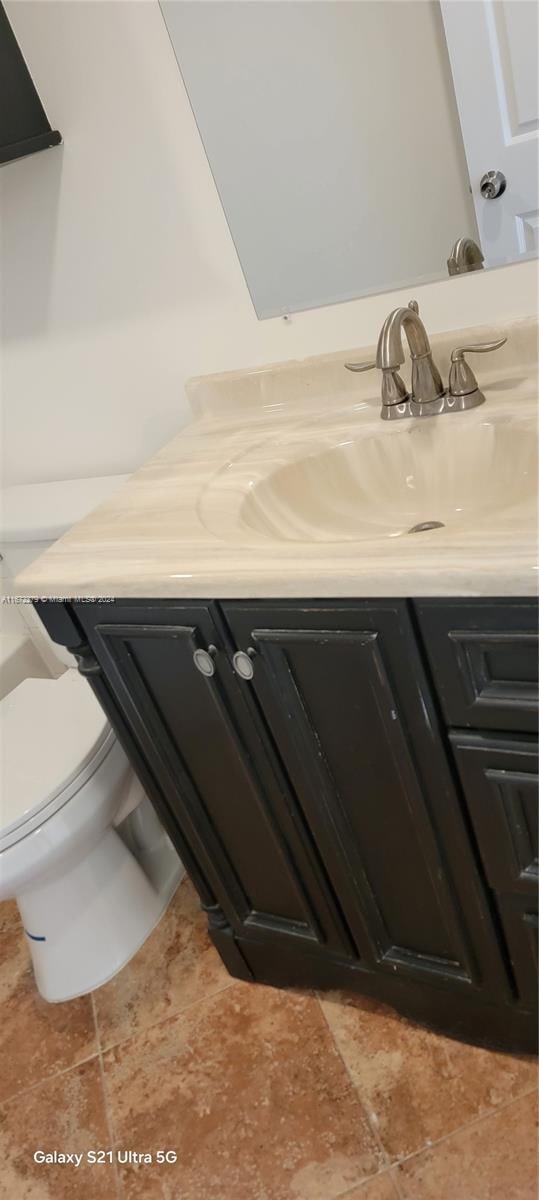 bathroom with tile patterned floors, vanity, and toilet