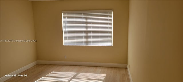 unfurnished room with plenty of natural light and light hardwood / wood-style flooring