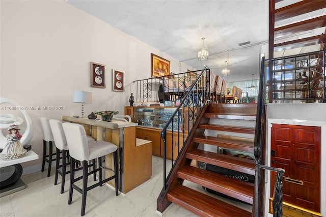 stairs with a chandelier