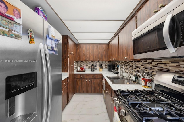 kitchen with stainless steel appliances, tasteful backsplash, and sink