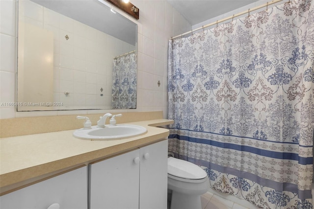 bathroom featuring vanity, tile walls, tile patterned flooring, curtained shower, and toilet