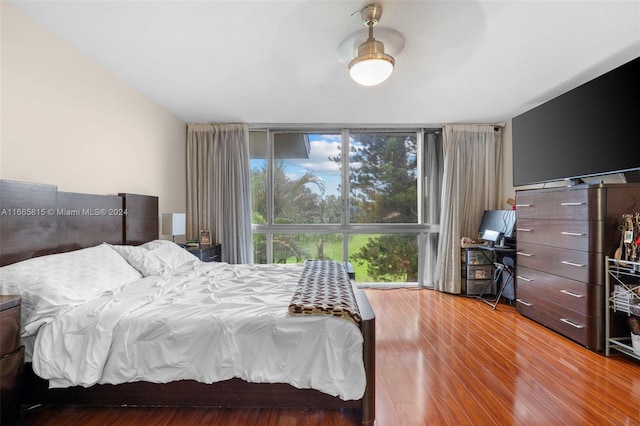 bedroom featuring multiple windows and hardwood / wood-style floors