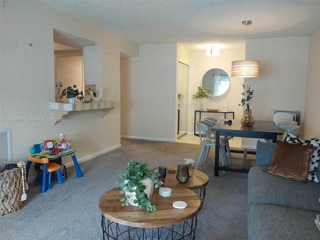 living room with carpet flooring and a textured ceiling