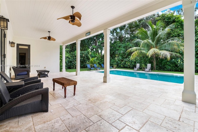 view of swimming pool featuring a patio and ceiling fan