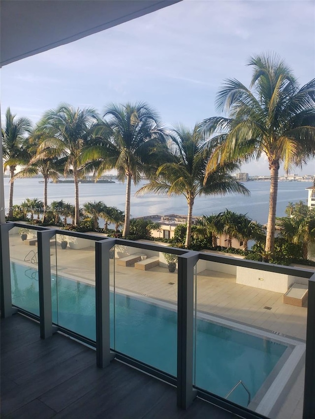 view of swimming pool featuring a water view