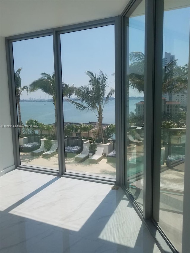 entryway featuring floor to ceiling windows and a water view