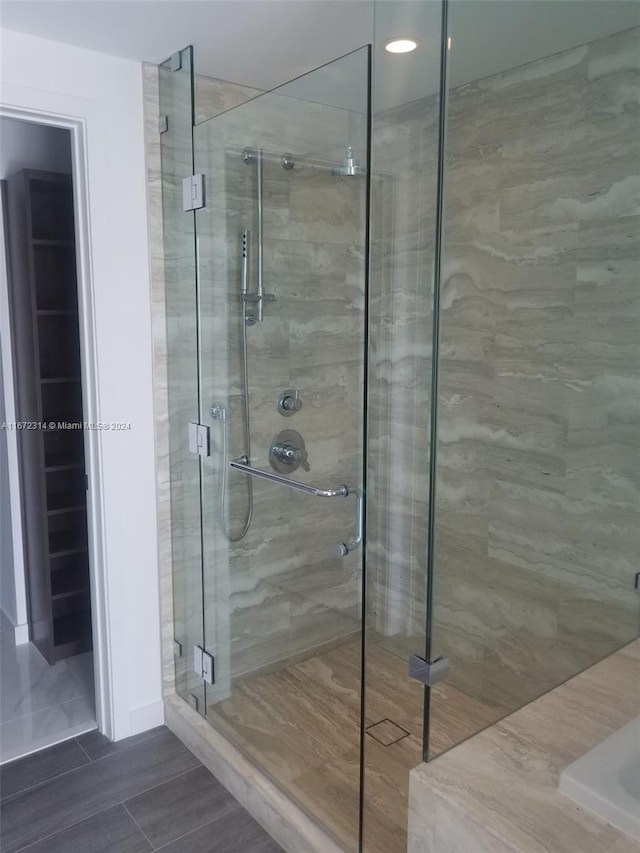 bathroom featuring a shower with shower door