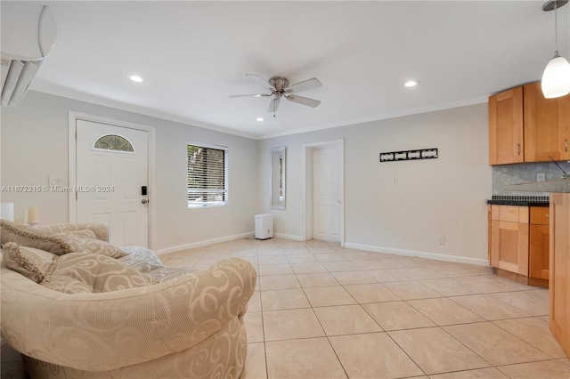 living room with ceiling fan, ornamental molding, and light tile patterned flooring