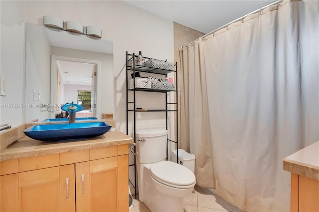 bathroom with vanity, toilet, curtained shower, and tile patterned flooring