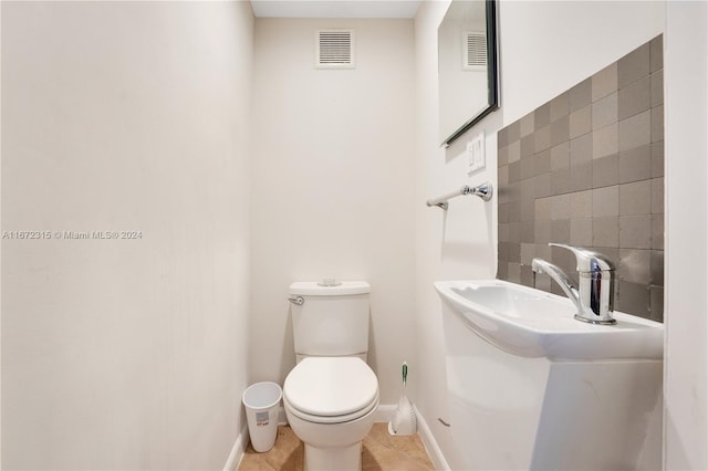 bathroom with toilet and tile patterned flooring