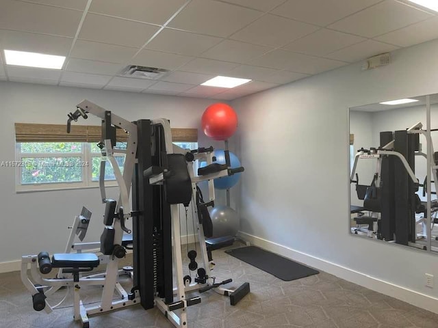 workout area featuring a paneled ceiling