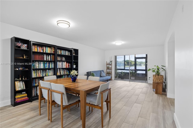 dining space with light hardwood / wood-style flooring