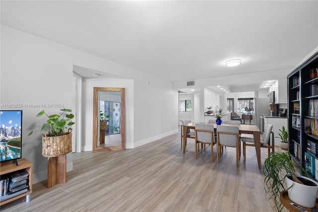 dining space featuring light wood-type flooring