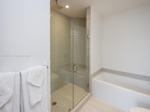 bathroom with toilet, separate shower and tub, and tile patterned floors