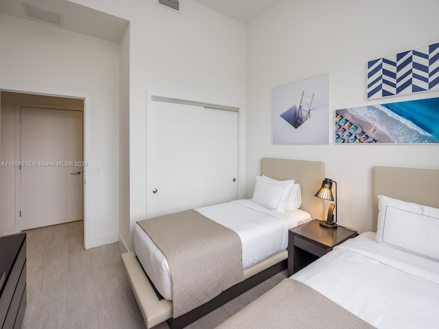 bedroom featuring light hardwood / wood-style floors and a closet