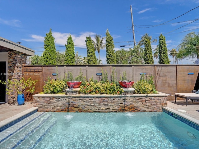 view of pool with pool water feature