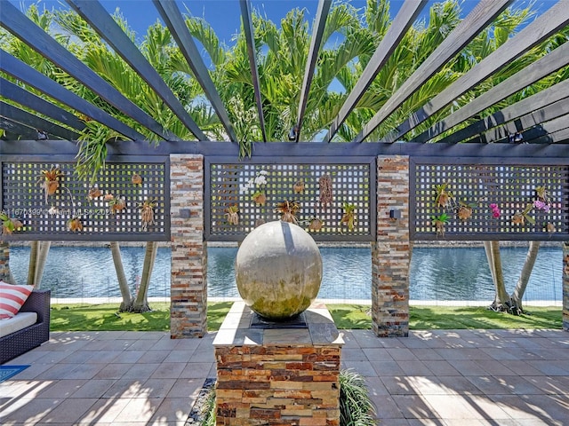 view of patio featuring a pergola and a water view