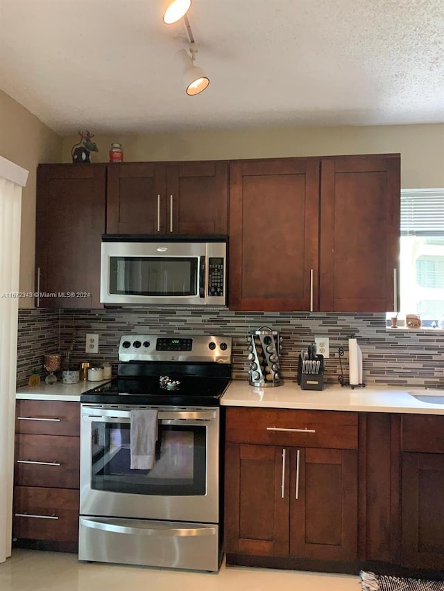 kitchen with appliances with stainless steel finishes and backsplash