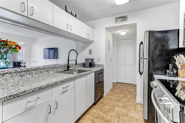 kitchen with white cabinets, sink, black dishwasher, white range with electric cooktop, and a textured ceiling