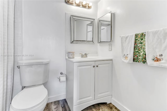 bathroom featuring hardwood / wood-style floors, vanity, and toilet