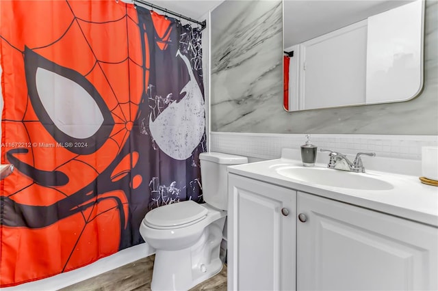 bathroom with curtained shower, vanity, toilet, and hardwood / wood-style flooring