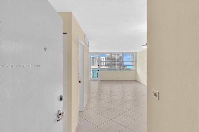 corridor featuring light tile patterned floors