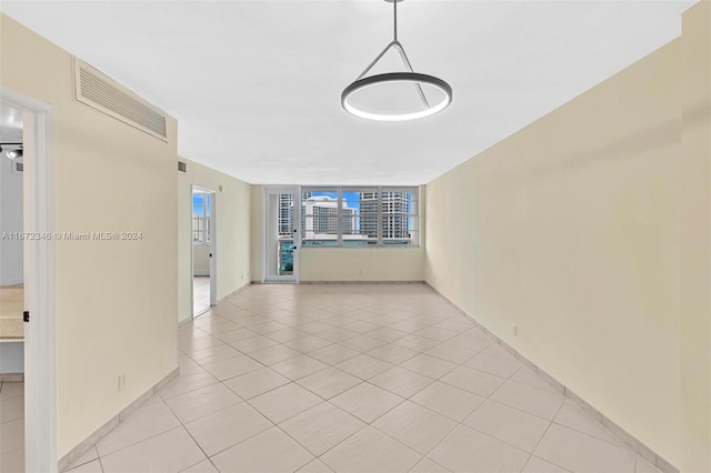 hall with light tile patterned floors