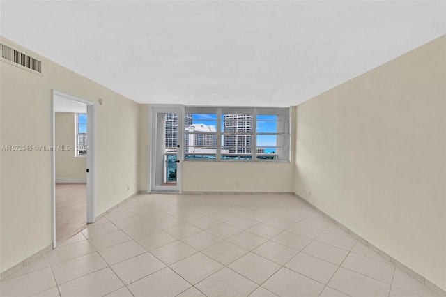 tiled empty room with a wealth of natural light