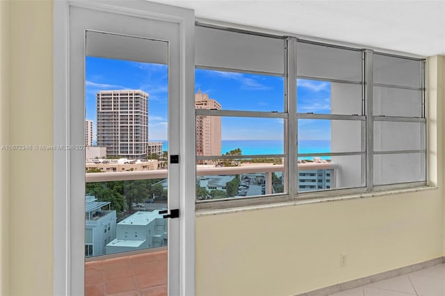 interior space featuring light tile patterned floors and a water view