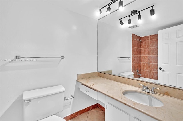 bathroom featuring tile patterned floors, vanity, and toilet