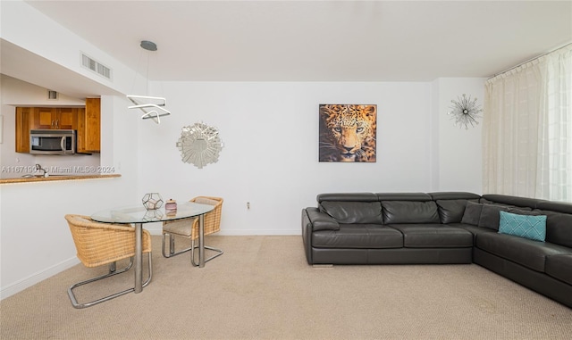 living room featuring light carpet