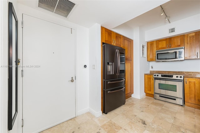 kitchen featuring stainless steel appliances and track lighting