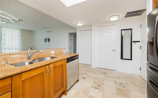 1745 E Hallandale Beach Blvd Unit 1804W, Hallandale Beach, FL 33009 - kitchen with visible vents, appliances with stainless steel finishes, light stone countertops, brown cabinets, and a sink