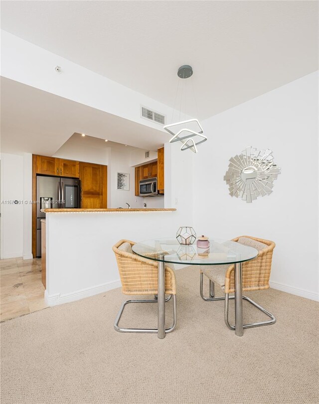 1745 E Hallandale Beach Blvd Unit 1804W, Hallandale Beach, FL 33009 - dining area with baseboards, light carpet, a notable chandelier, and visible vents